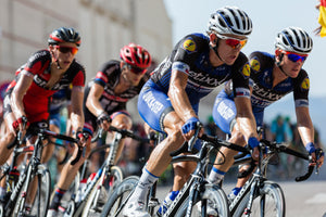 Group of cyclists riding in a line and side by side