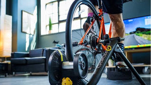 Muscular legs of man VR training for endurance on a stationary bike