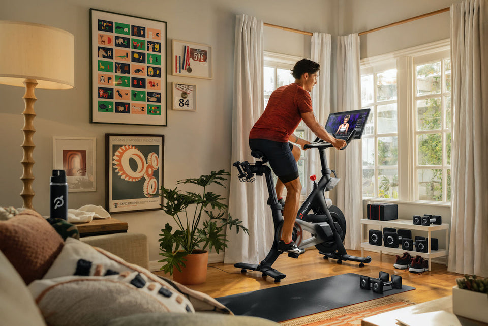 Man riding Peloton bike in his living room