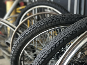 Row of bicycle wheels with and without tires on them