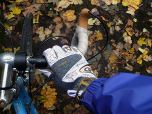 Cyclist’s gloved hand on the handlebars of a bike