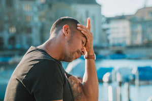 Man with hand on head looking distressed and worried