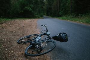 Road bike that’s fallen over on the side of the road