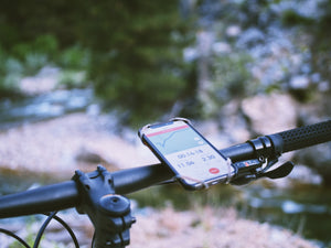 Smartphone attached to bicycle handlebars monitoring workout data