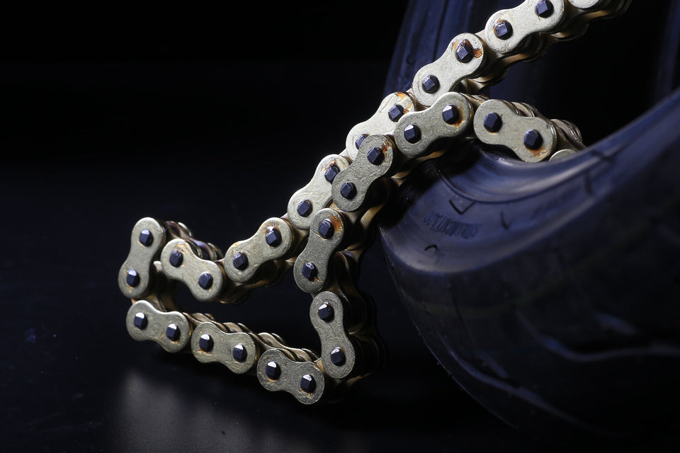 Bike chain that has been removed from a bike, sitting partially inside a tire