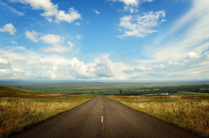 View downhill on a long, straight country road 