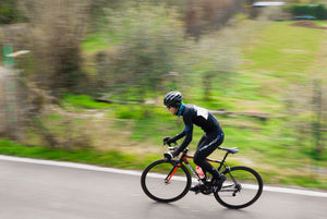 Cyclist wearing multiple layers as he rides in the cold