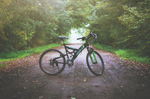 Empty bicycle on a wooded dirt road