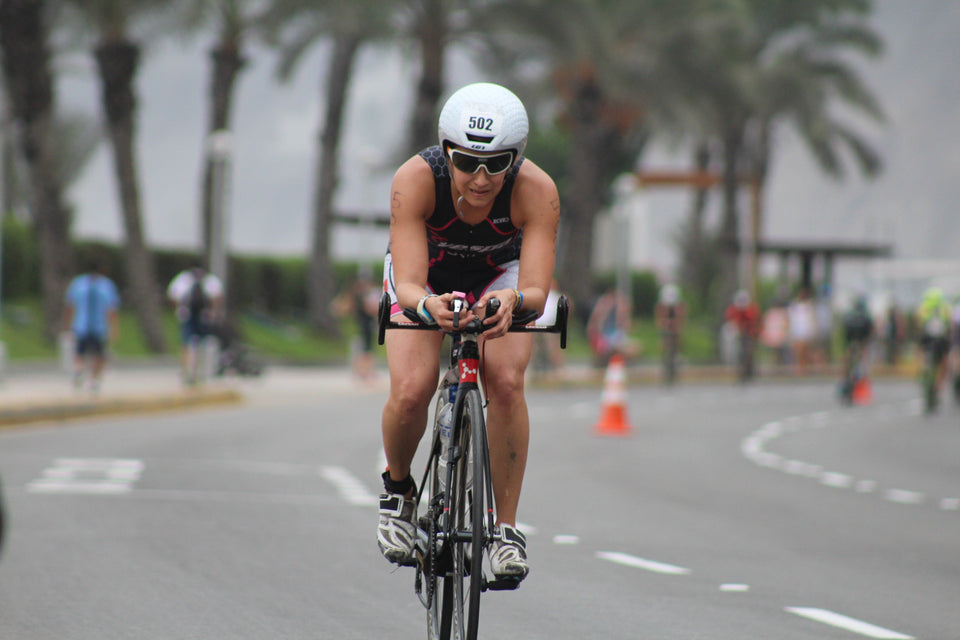 Woman cycling on road with tired expression