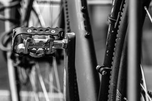 Black-and-white close-up of a clipless mountain bike pedal