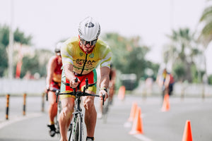 Cyclist grimacing as he pedals onward