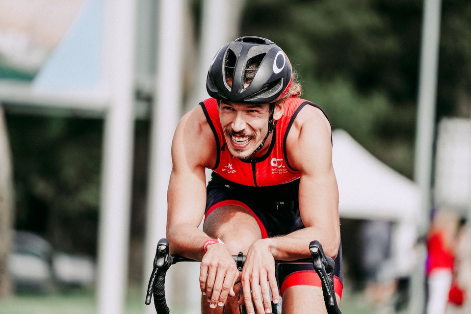 Cheerful cyclist riding a bicycle during a cycling event