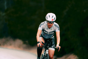 Woman cyclist pedaling hard and looking focused