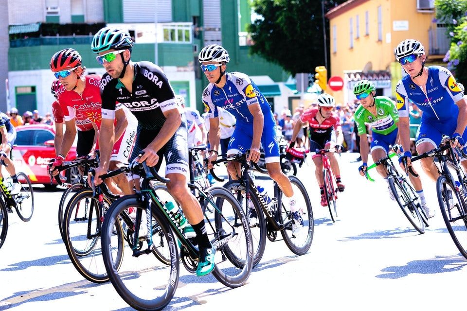 Group of road cyclists pedaling uphill