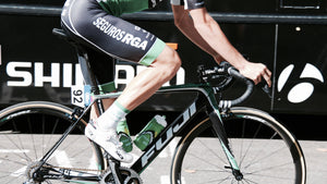 Close-up on a cyclist’s legs while pedaling on a ride