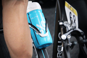 Close-up of a blue and white water bottle in its holster on a bike frame
