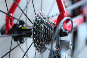 Close-up of a rear-wheel bicycle gear cassette on a red bike