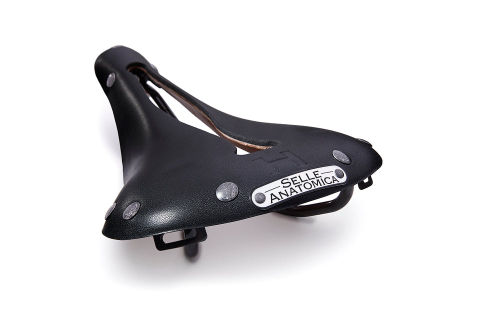 The H1 leather bicycle saddle in black and gunmetal, showing off the Selle Anatomica nameplate