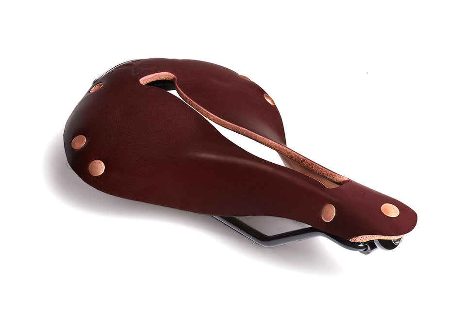 The Selle Anatomica X1 bicycle saddle in reddish brown oxblood leather with copper colored rivets and comfortable Flex-Fly slot